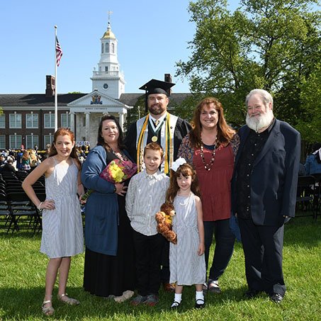 Jeremiah poses with his family at commencement
