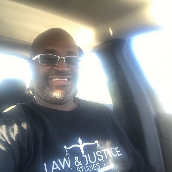 Carl wearing a Rowan Law and Justice t-shirt