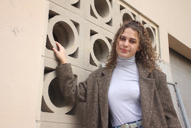 student on campus smiling at camera