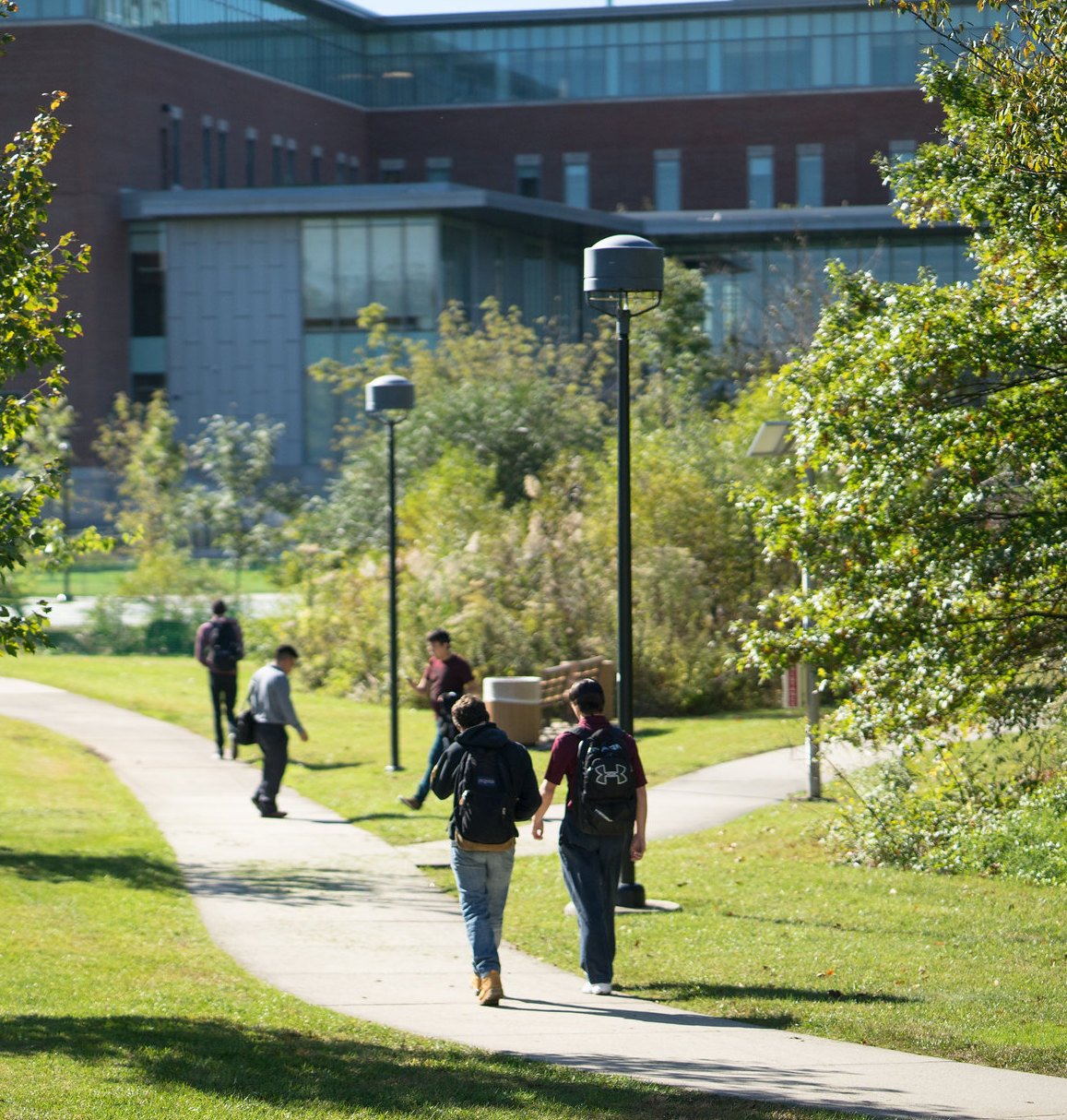 Two students walking by Business Hall