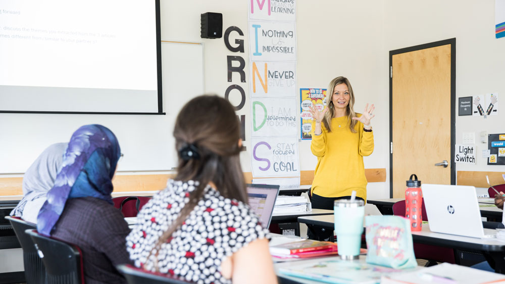A school administrator speaks with other teachers.