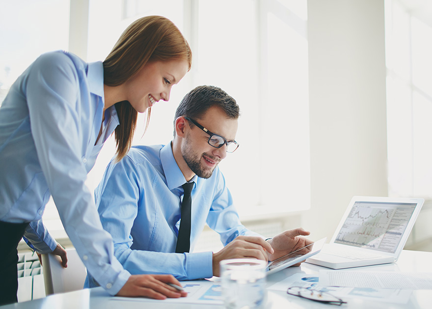 two professionals working together at a desk