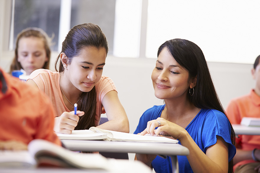 a teacher and children work together in the classroom