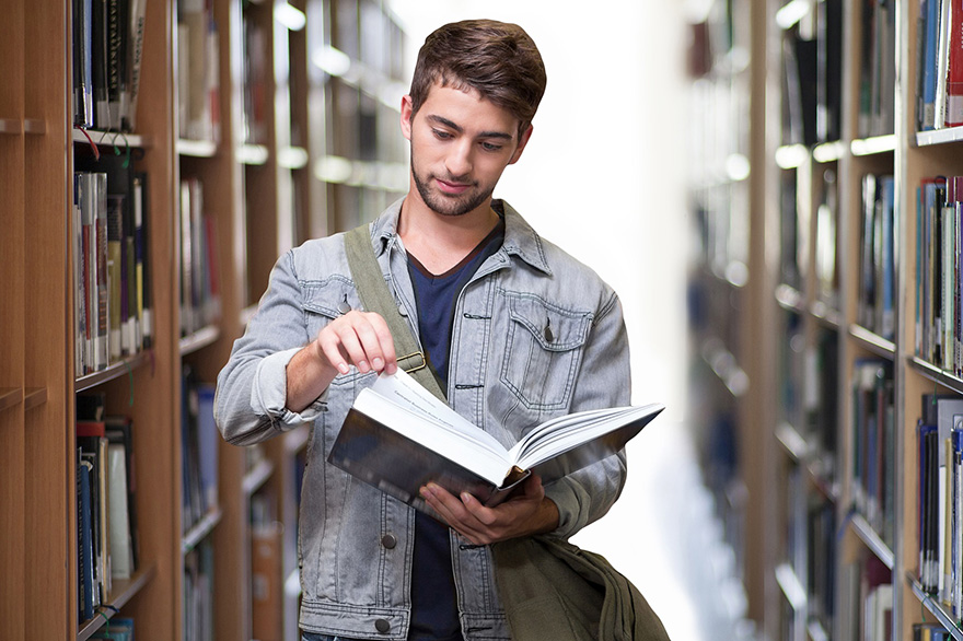 a man reads a book in the library