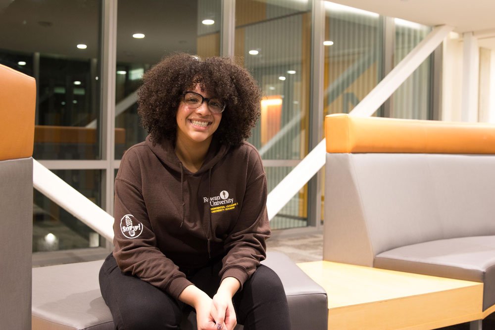 Residence Life staff member sits in a residence hall sitting area