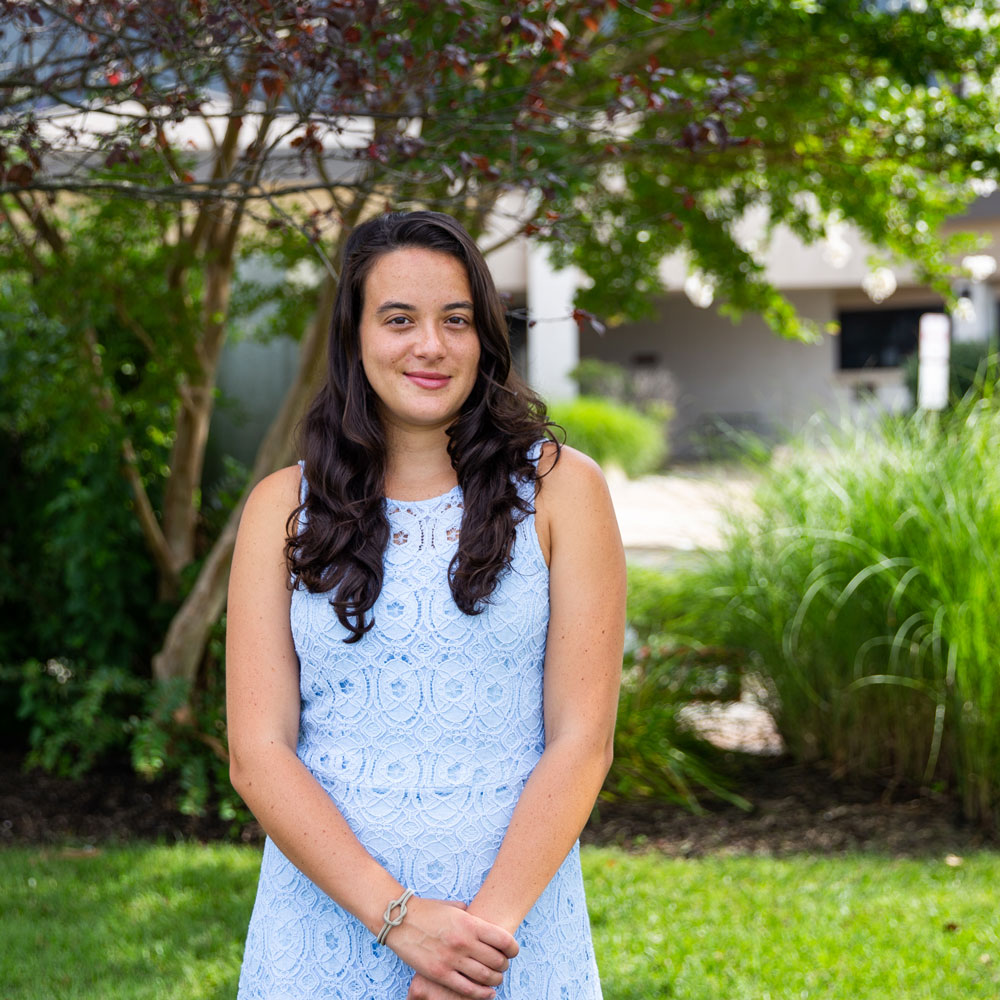 Computer Science major Maria stands outside