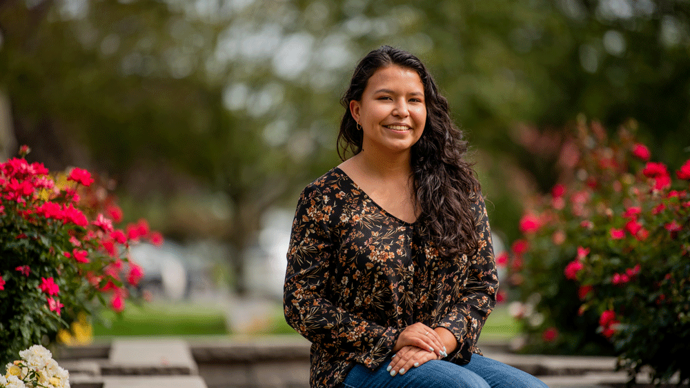 Student sits outside on campus.